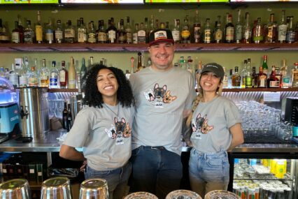 Three restaurant workers looking at the camera
