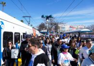 A crowd of people at a public transit stop in Santa Clara, California