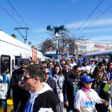 A crowd of people at a public transit stop in Santa Clara, California