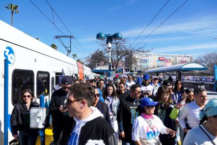 A crowd of people at a public transit stop in Santa Clara, California