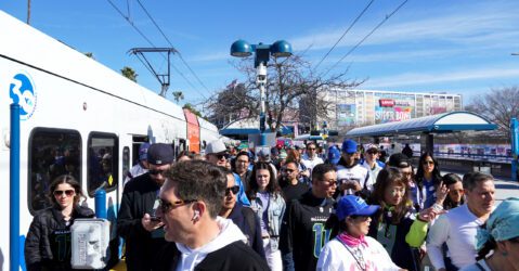 A crowd of people at a public transit stop in Santa Clara, California