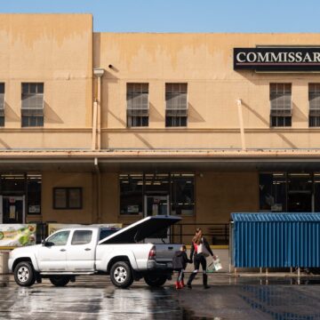 A woman and boy walking into building