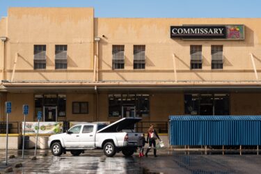 A woman and boy walking into building