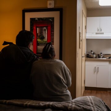 Palo Alto Sunnyvale homeless Embarcadero Two people sitting on a bed