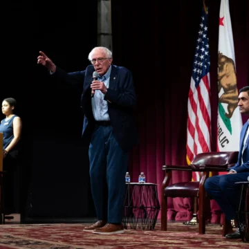 U.S. Senator Bernie Sanders and Rep. Ro Khanna on stage during a town hall on artificial intelligence at Stanford University in California