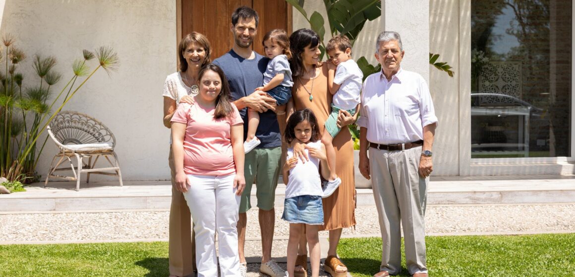 Multigenerational living A multigenerational family standing in front of their home