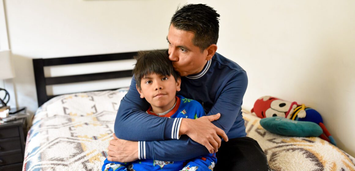 HOMELESSNESS PREVENTION PROGRAM A father sitting at home with his son