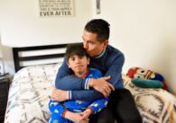 A father sitting at home with his son