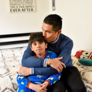 A father sitting at home with his son