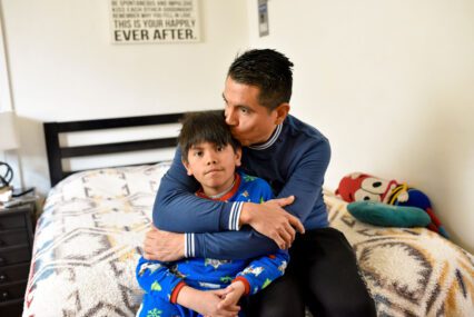 A father sitting at home with his son