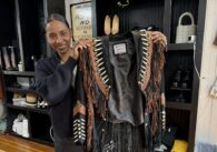 A woman holding a jacket in a clothing store in San Jose, California