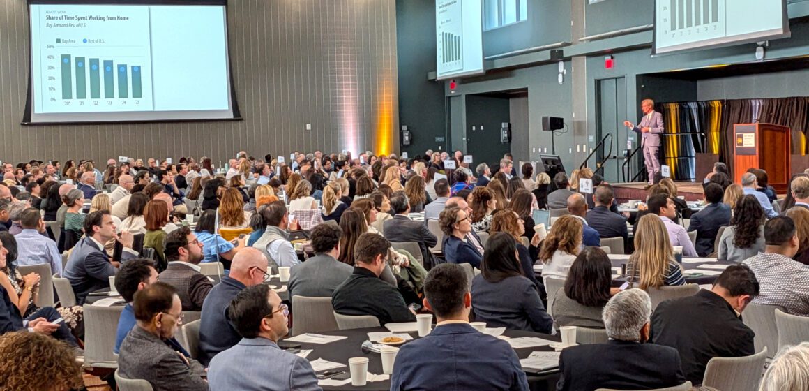 State of the Valley A crowd of people seated at tables watching a man speak onstage in San Jose, California