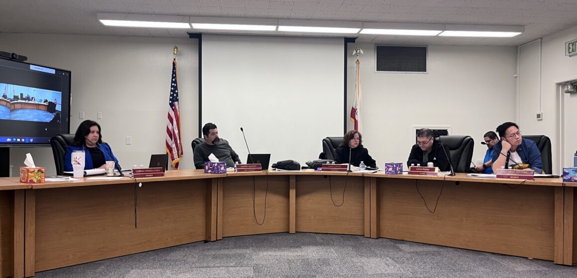A group of men and women sitting behind dais at a school board meeting in San Jose, California