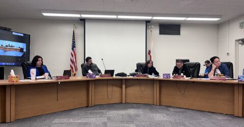 A group of men and women sitting behind dais at a school board meeting in San Jose, California