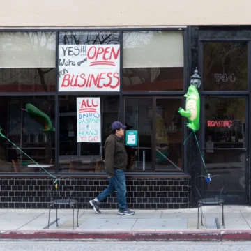 Man walking by vacant stores in Mountain View, California