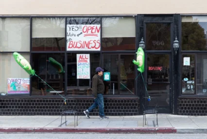 Man walking by vacant stores in Mountain View, California