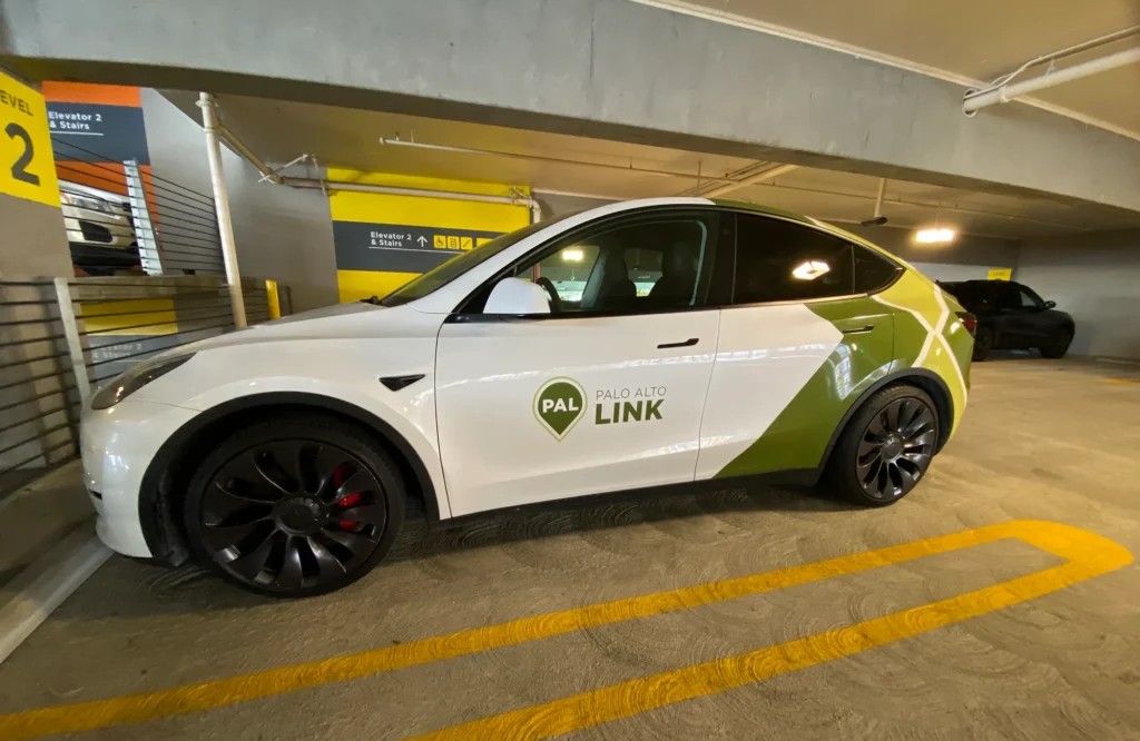 A ride-share vehicle parked in a parking garage