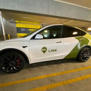 A ride-share vehicle parked in a parking garage
