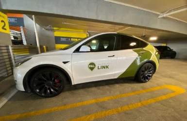 A ride-share vehicle parked in a parking garage
