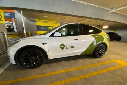 A ride-share vehicle parked in a parking garage