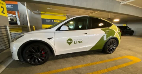 A ride-share vehicle parked in a parking garage