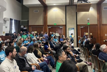 A group of people in chairs at a water board meeting in San Jose, California