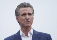 A man in a suit staring off into the distance