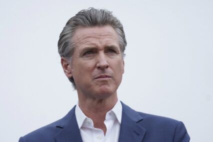 A man in a suit staring off into the distance