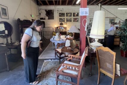 A woman looking at furniture in a thrift shop in San Jose, California