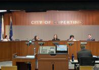 Members of a city council behind the dais at a government meeting in Cupertino, California