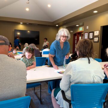 People at a table at an activity center in San Jose, California