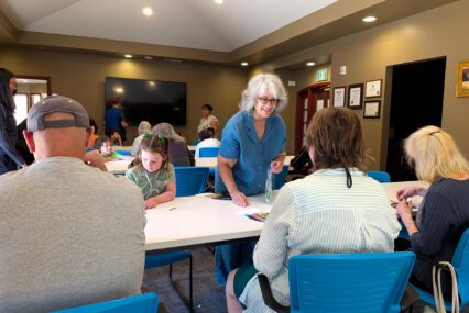 People at a table at an activity center in San Jose, California