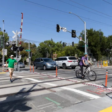 Palo Alto train crossing Embarcadero Pedestrians and cars crossing train tracks in Palo Alto, California