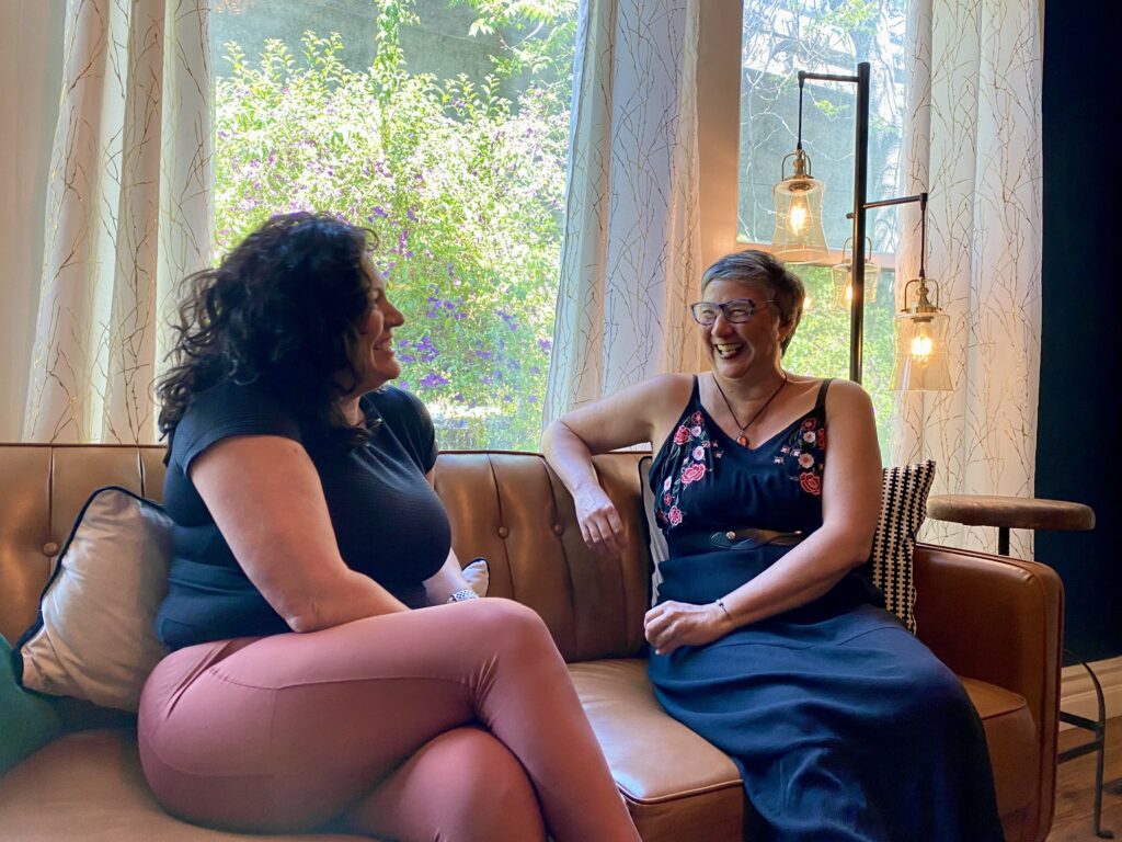Two women sitting on a couch