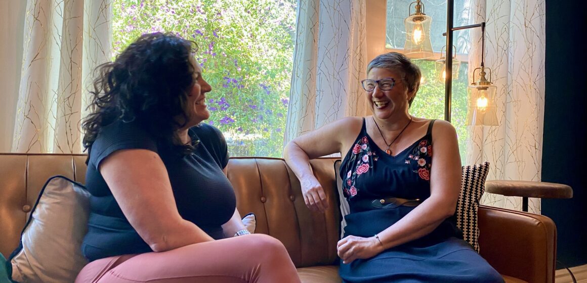 Two women sitting on a couch