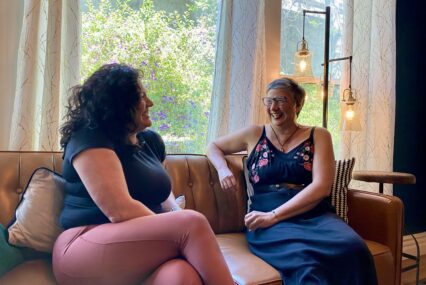 Two women sitting on a couch