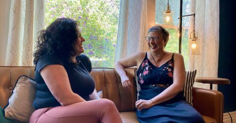 Two women sitting on a couch