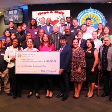 SCC Reentry A group of people being presented with a giant check
