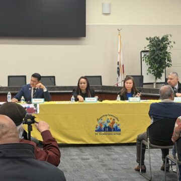 Four candidates sitting at a yellow table