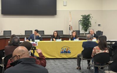 Four candidates sitting at a yellow table