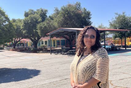 A woman stands on the campus of a charter school in San Jose, California