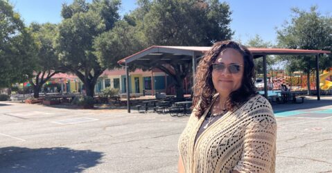 A woman stands on the campus of a charter school in San Jose, California