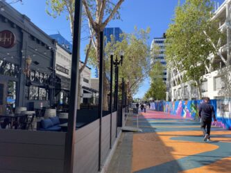 Al Fresco Outdoor Dining Pedestrians walk by outdoor dining spaces in San Jose, California