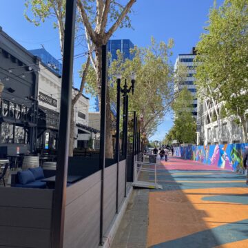 Al Fresco Outdoor Dining Pedestrians walk by outdoor dining spaces in San Jose, California