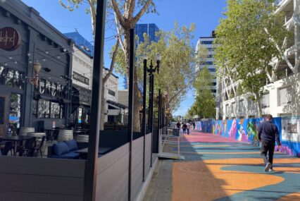 Pedestrians walk by outdoor dining spaces in San Jose, California