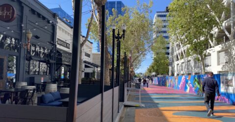 Pedestrians walk by outdoor dining spaces in San Jose, California