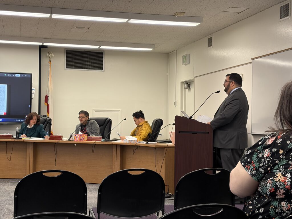 A man speaks at a podium at a school board meeting in San Jose, California