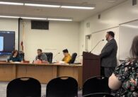 A man speaks at a podium at a school board meeting in San Jose, California