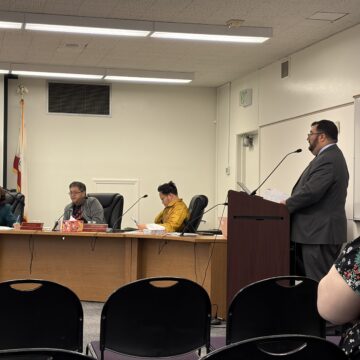 A man speaks at a podium at a school board meeting in San Jose, California
