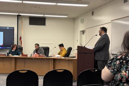 A man speaks at a podium at a school board meeting in San Jose, California